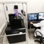 Scientist working with a scanning electron microscope in a lab
