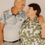 A smiling senior couple standing together at home