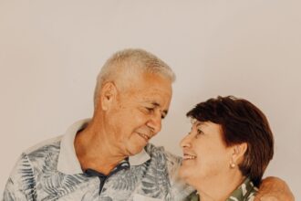 A smiling senior couple standing together at home