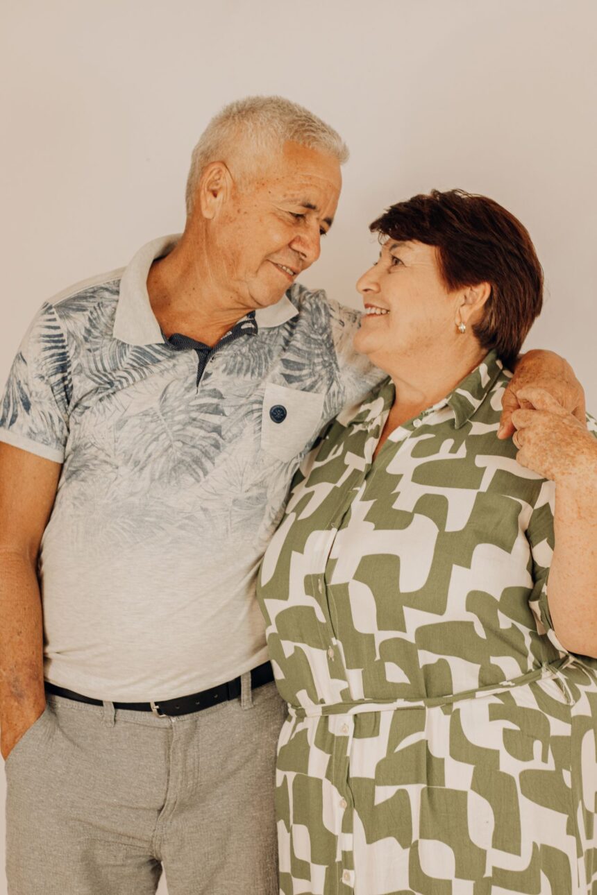 A smiling senior couple standing together at home