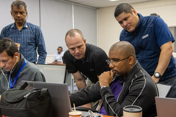 Cyber security team monitoring computer systems at workstations