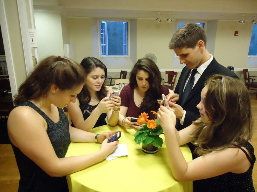 A young person watching videos on a smartphone
