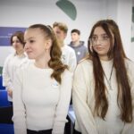 Happy school students talking together at break without phones